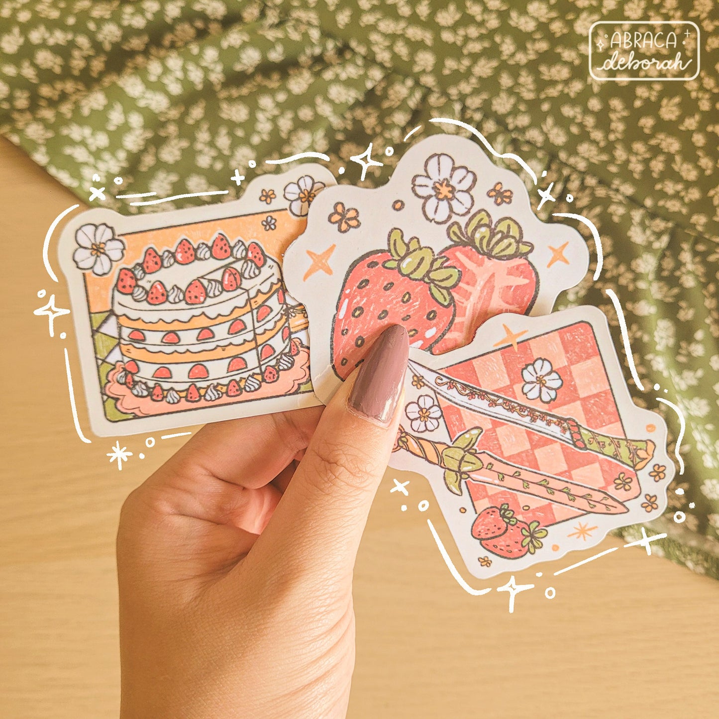 Three stickers: strawberries, cake, and two swords.