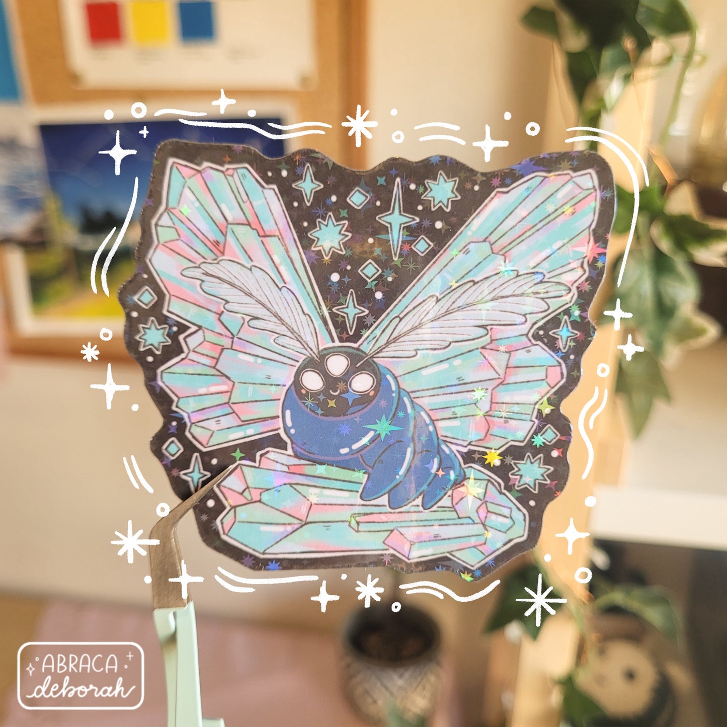 Holographic sticker of a luminous moth with three eyes, featherlike antennae and wings made of iridescent crystals.