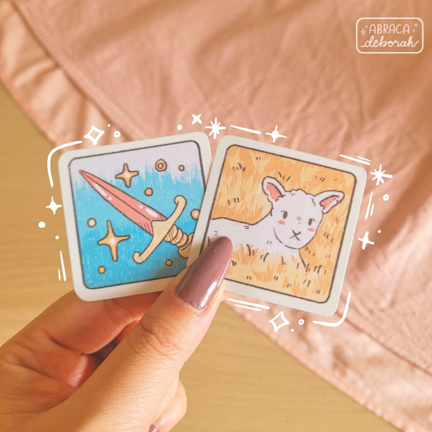 Two square stickers: a sword and a lamb.