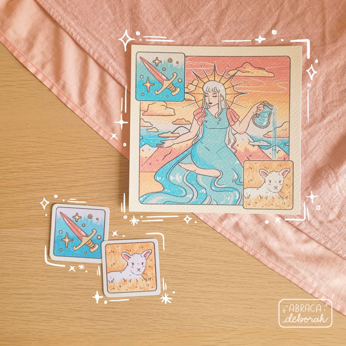 A square print depicting a nature goddess, and two square stickers depicting a sword and lamb.