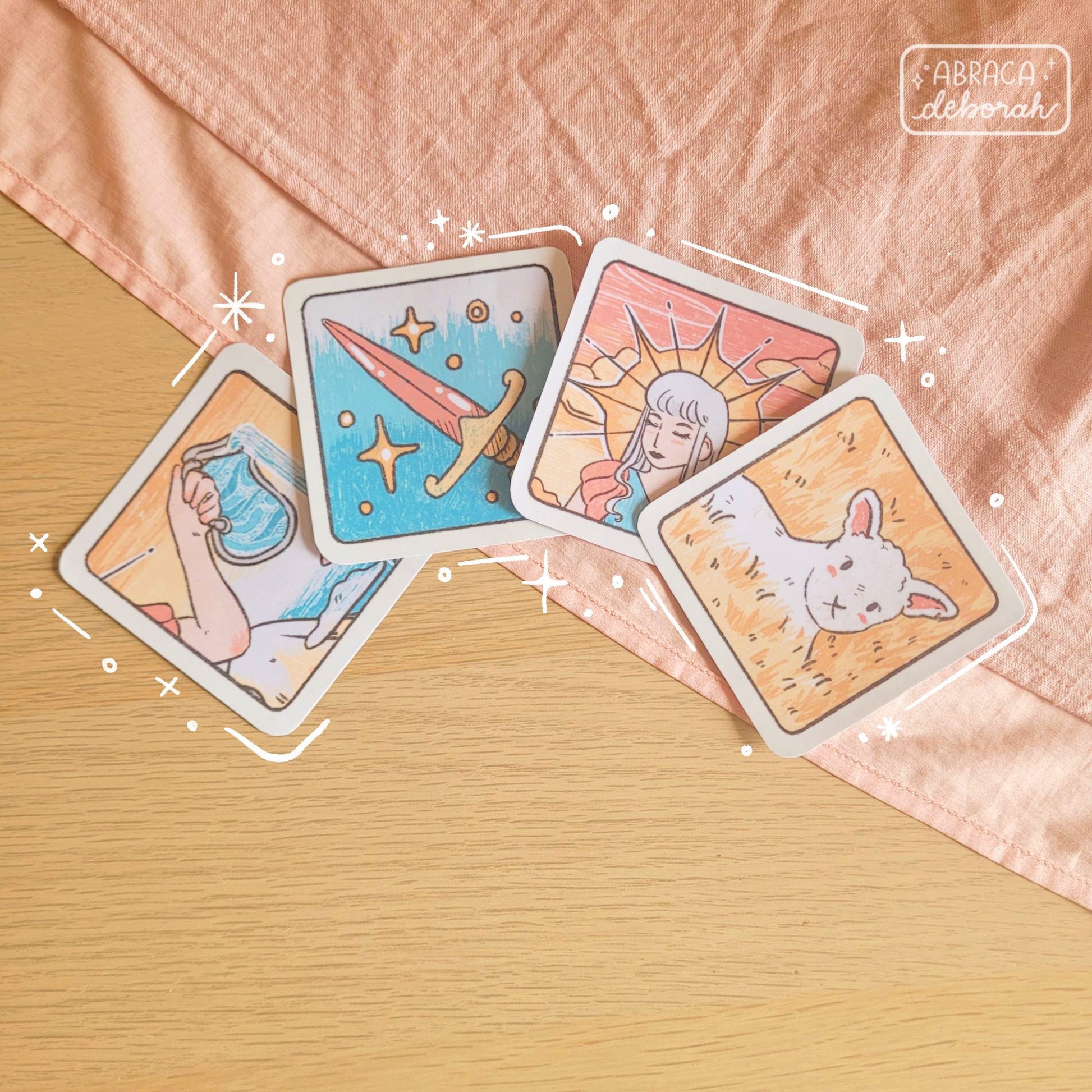 Four square stickers: a pink sword, a lamb, a pouring jug, a lady with a crown.