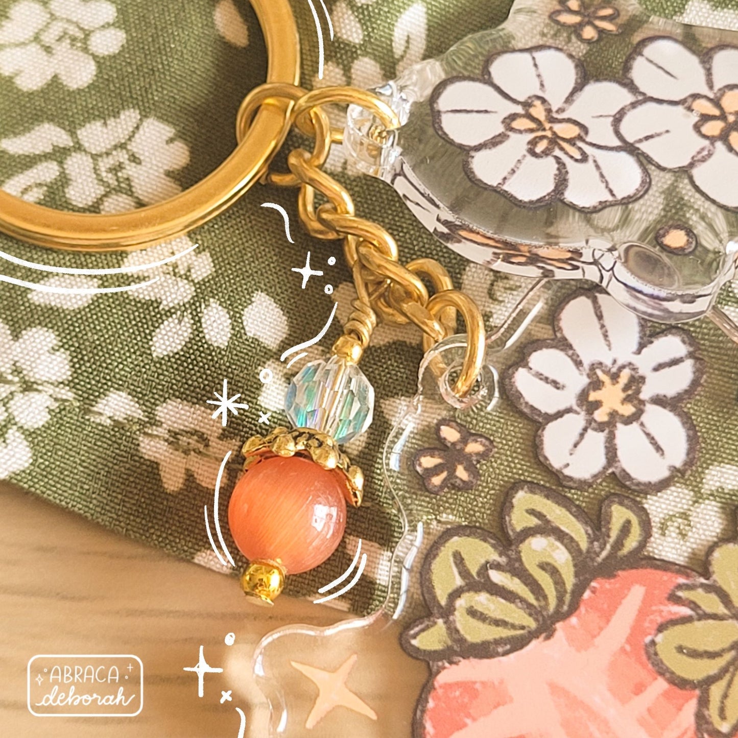 Clear acrylic keychain with beads, flowers and strawberries.