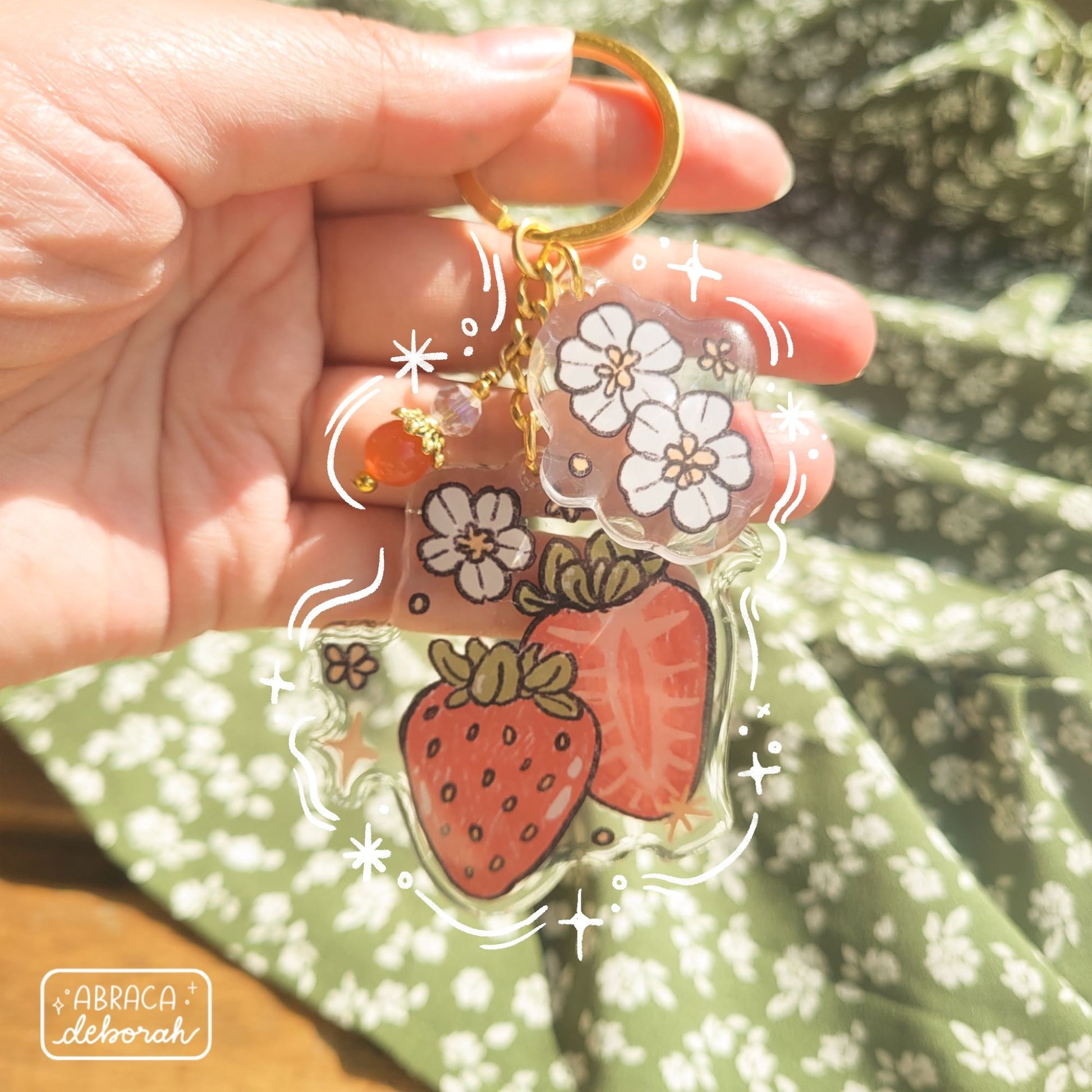 Clear acrylic keychain with beads, flowers and strawberries.