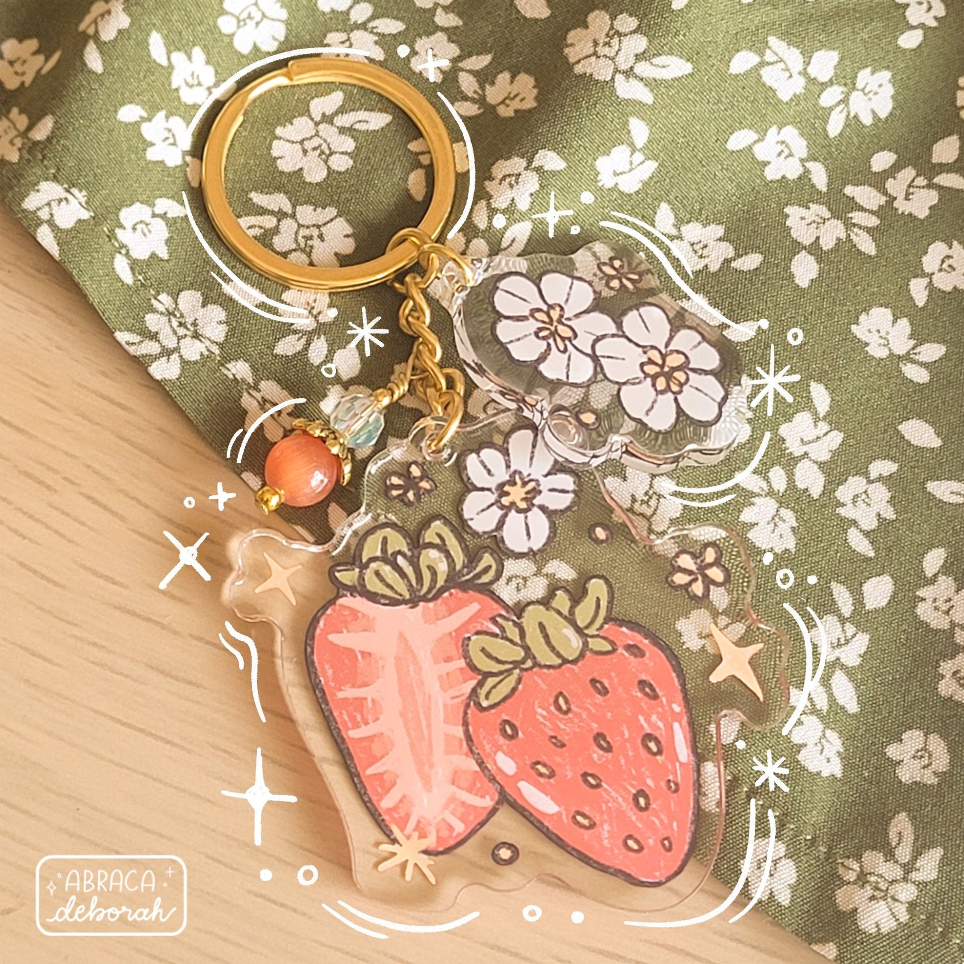 Clear acrylic keychain with beads, flowers and strawberries.