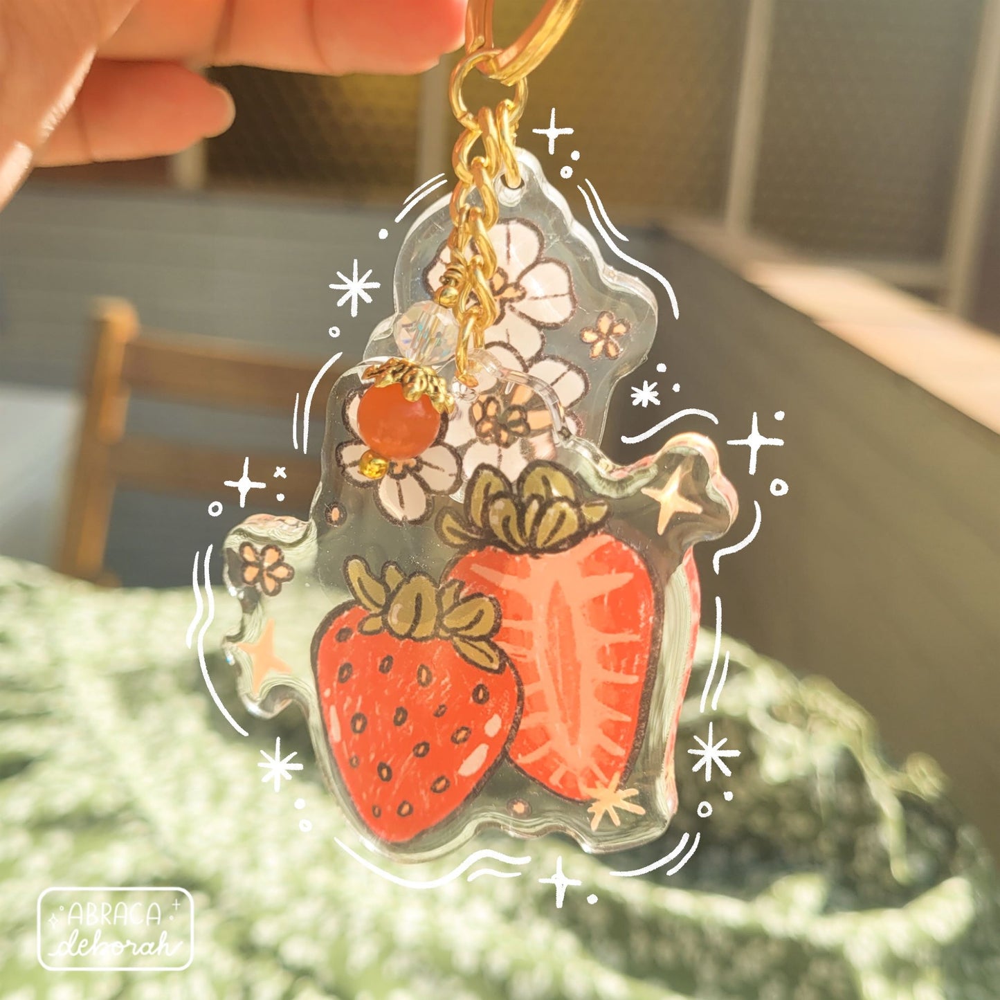 Clear acrylic keychain with beads, flowers and strawberries.