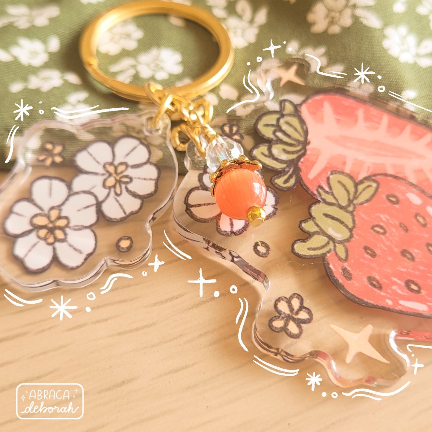 Clear acrylic keychain with beads, flowers and strawberries.