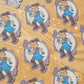 Stickers depicting a male character holding a boomerang as if he is about to throw it. There is a full moon behind him.