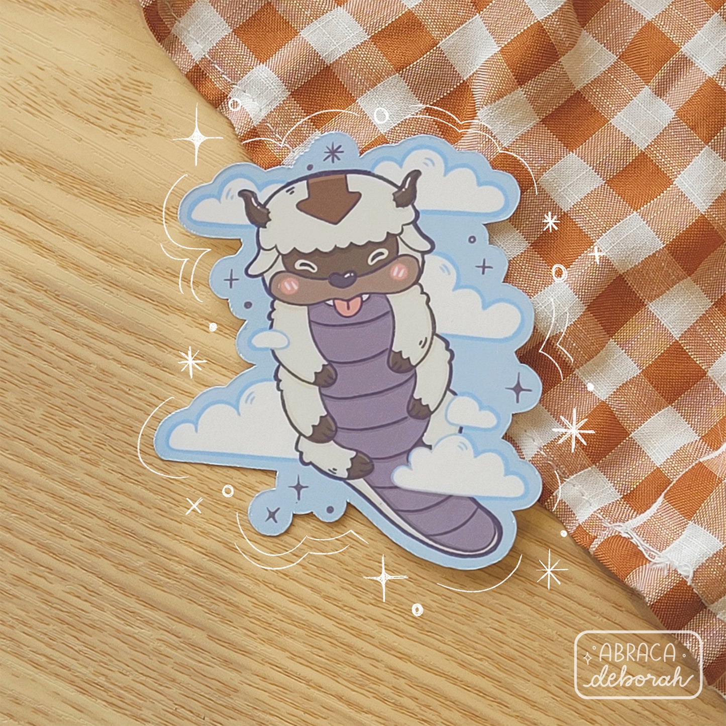 Sticker of a bison with an arrow on his head. There are clouds behind him.