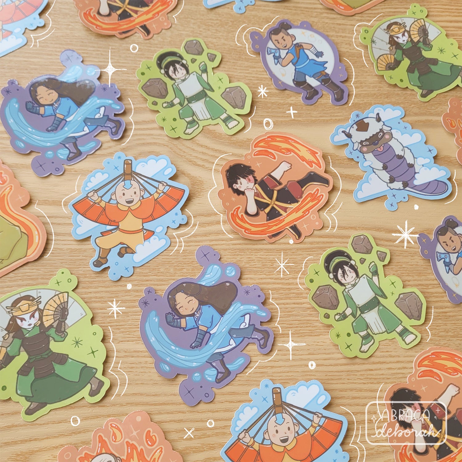 Stickers with different characters on them are laid neatly on a table.